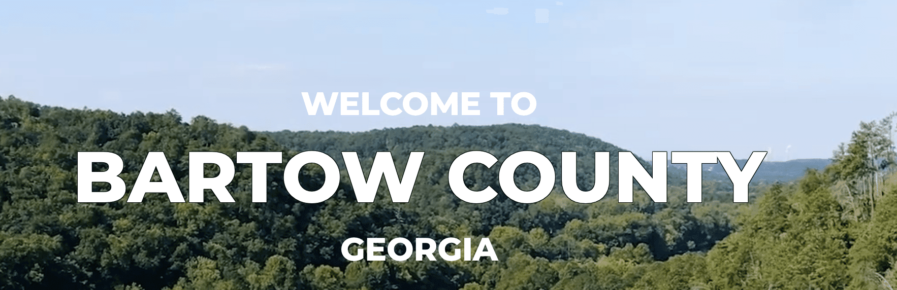 Welcome sign for Bartow County, Georgia, with a scenic view of green hills. Welcome sign for Bartow County, Georgia, with a scenic view of green hills.